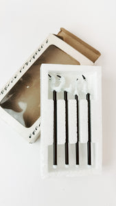 Two sets of glass drink stirs